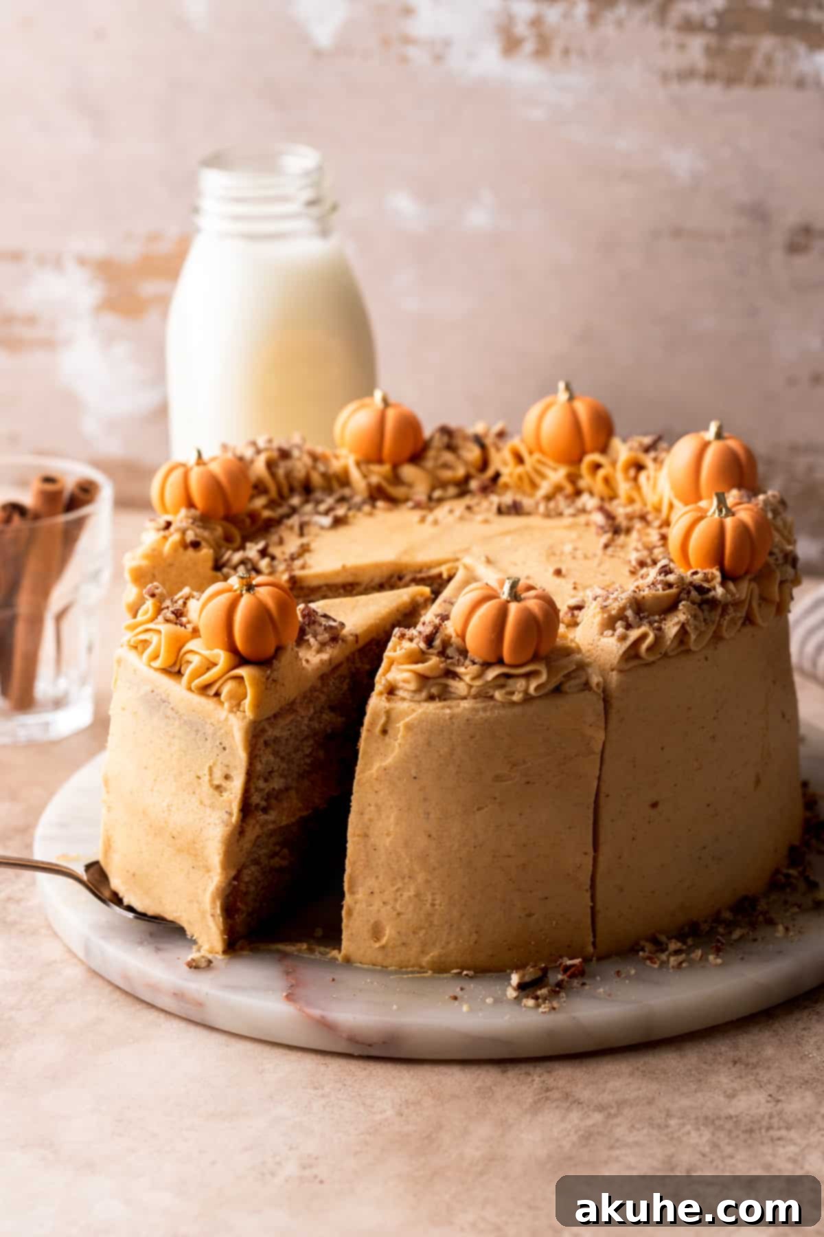 Chai Spiced Cake 3 Beautifully decorated chai cake with pumpkin frosting on a elegant marble cake stand.