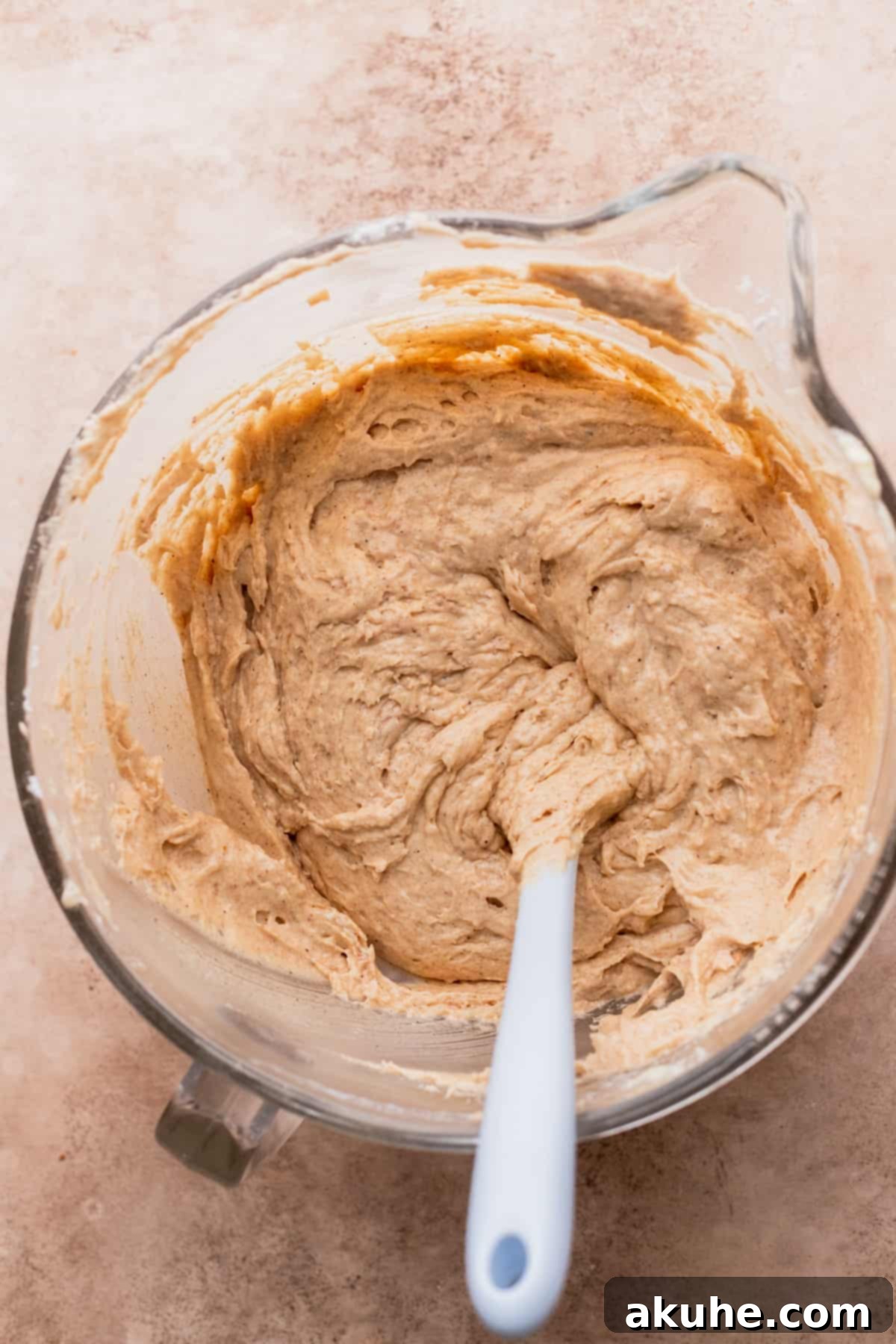 Chai Spiced Cake 5 Rich, spiced cake batter in a clear glass bowl, ready for baking.