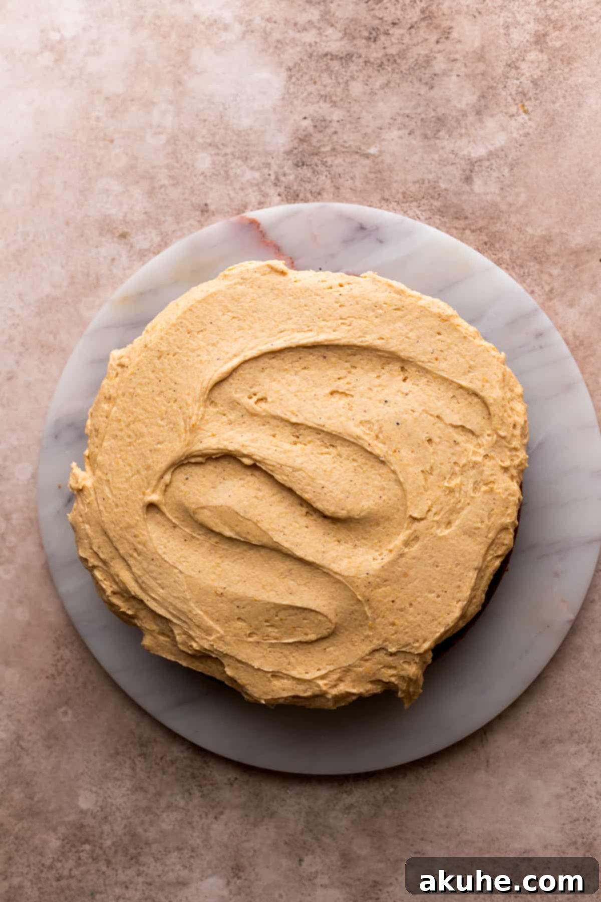 Chai Spiced Cake 8 Generous layer of pumpkin frosting spread evenly on one cake layer.