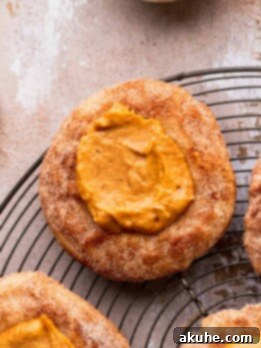 Pumpkin pie cookies on a wire rack topped with cinnamon sugar.