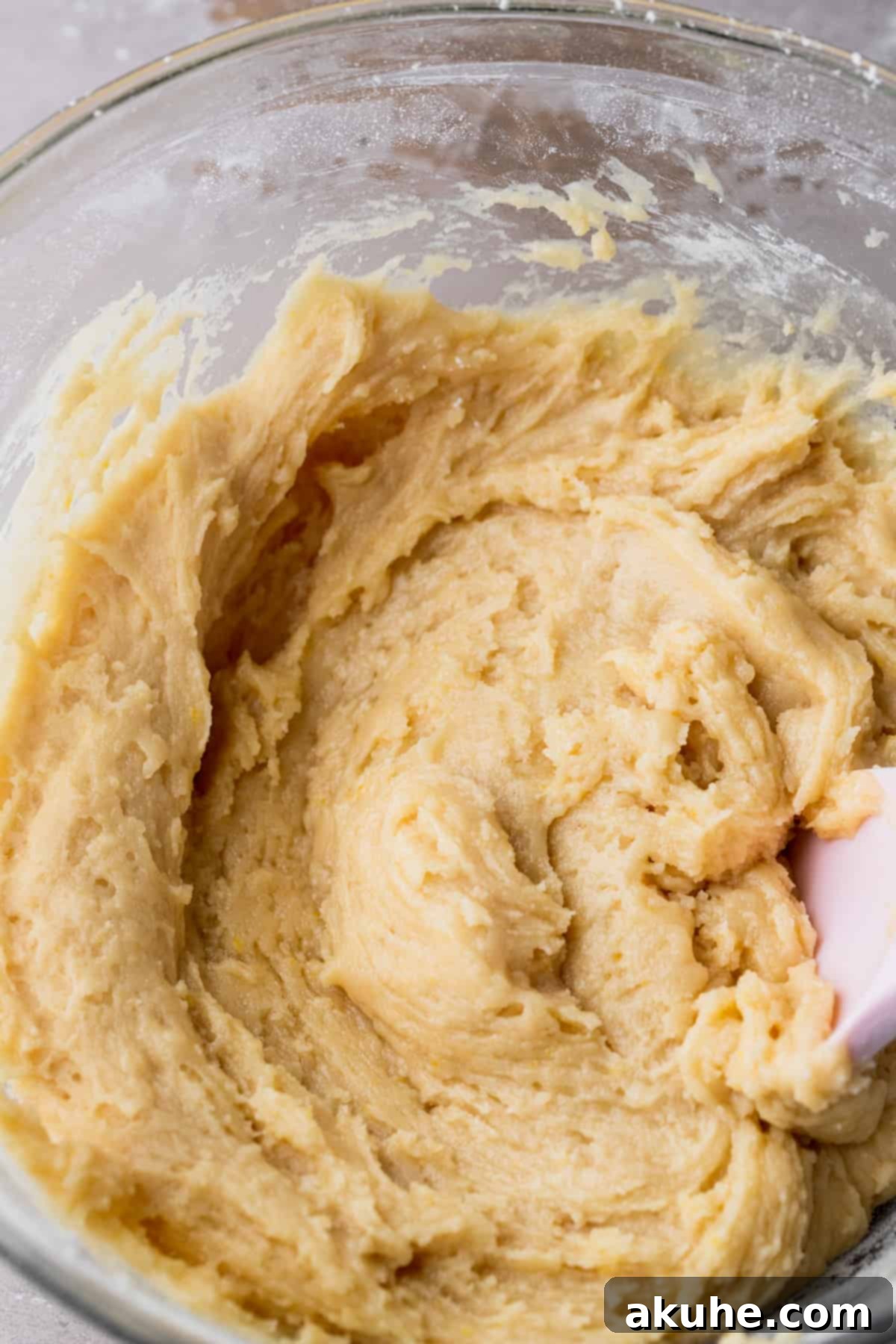 Prepared cookie dough in a clear glass bowl, ready for scooping.