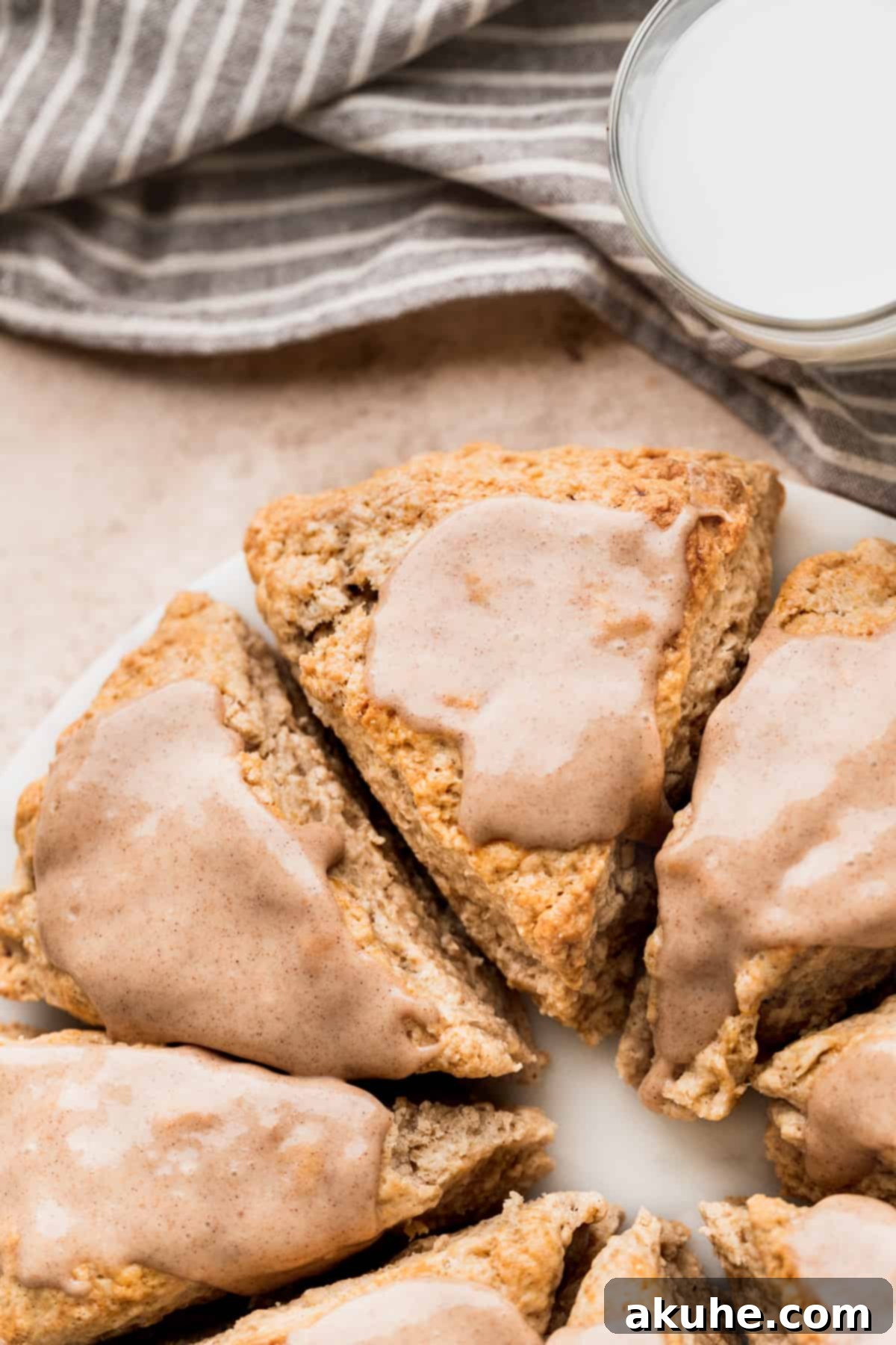 Banana Bread Scones 11 These cinnamon banana scones, freshly glazed, are presented on a white marble board.