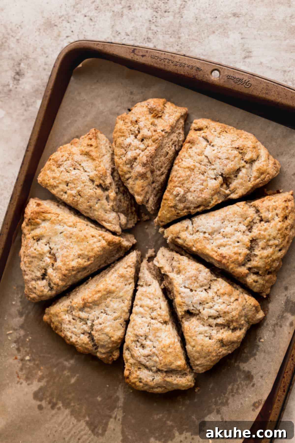 Banana Bread Scones 9 Golden-baked scones cooling on parchment paper after coming out of the oven.