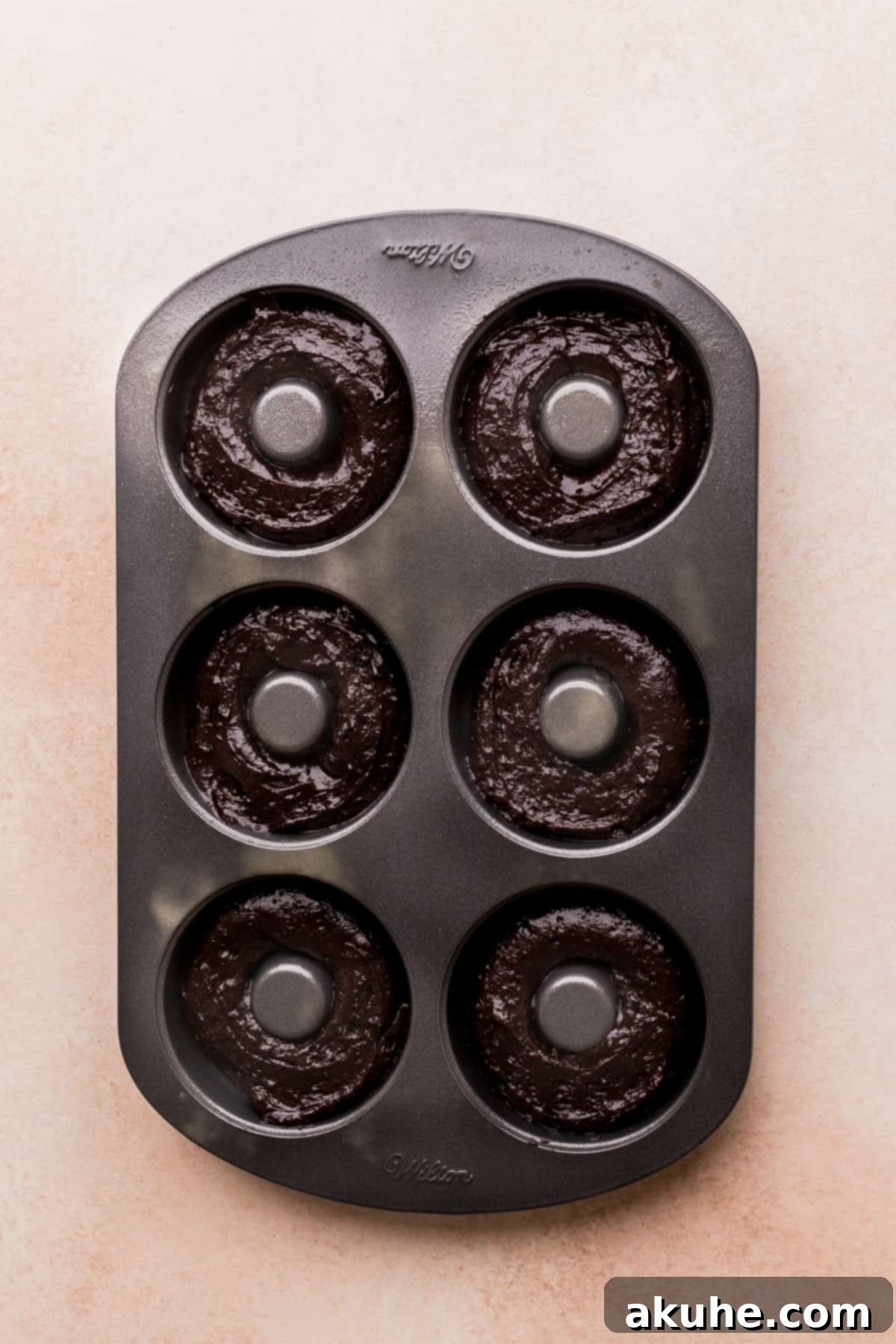 Cookies and Cream Doughnuts 6 Donut cake batter precisely piped into a donut pan.