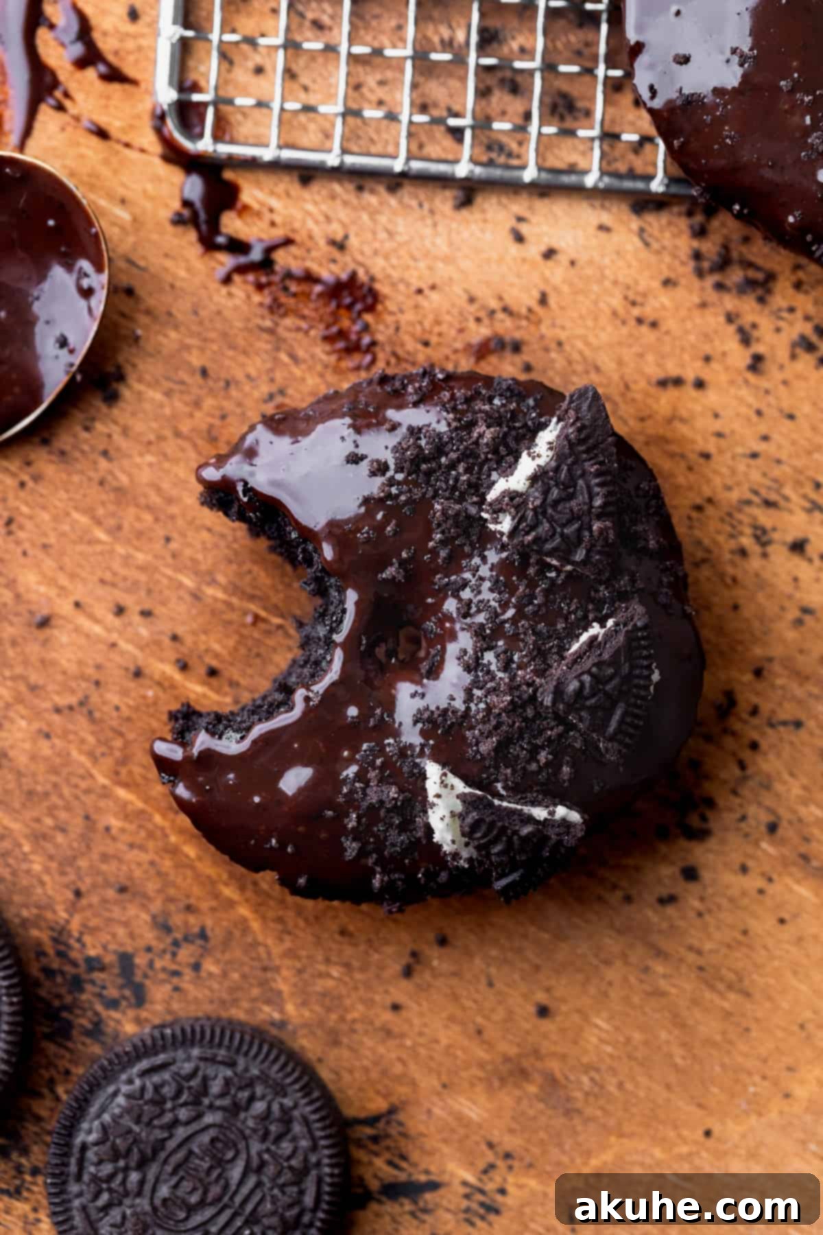 Cookies and Cream Doughnuts 8 A single Oreo donut with a bite taken out, showing its fluffy interior.