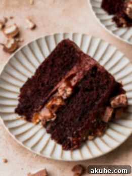 Ultimate Twix Cake 12 Slice of twix cake on a plate.