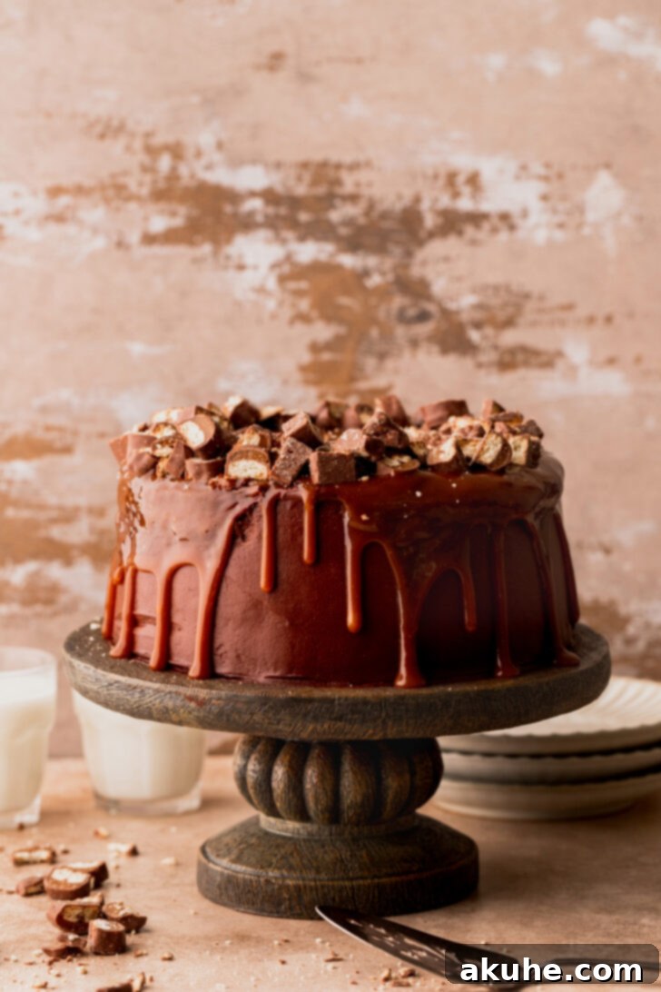 Ultimate Twix Cake 9 Fully decorated Twix cake with caramel drips and chopped Twix on top.