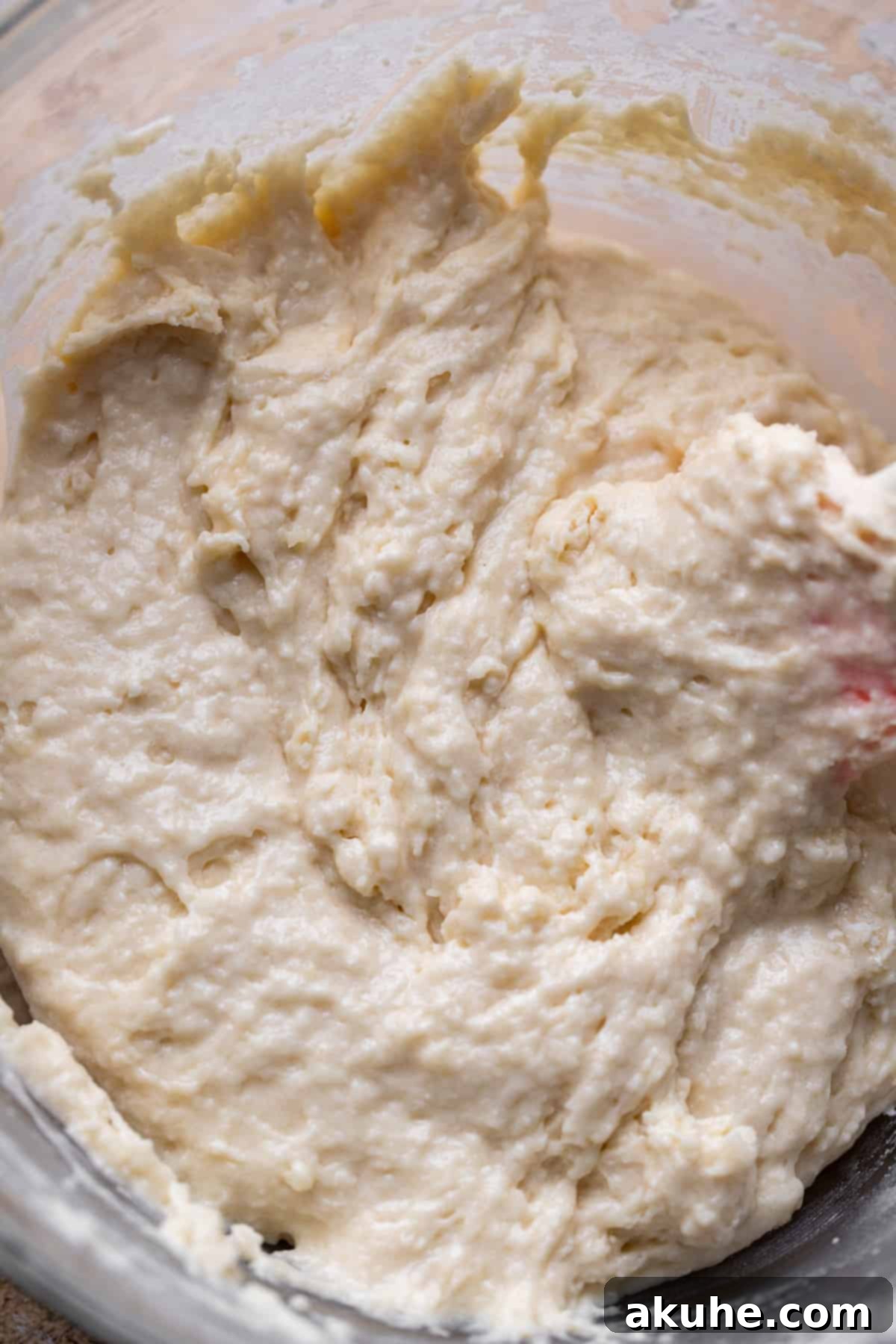 Decadent Chocolate Donut Delights 5 A glass bowl containing the smooth, combined donut cake batter, showcasing its light consistency.