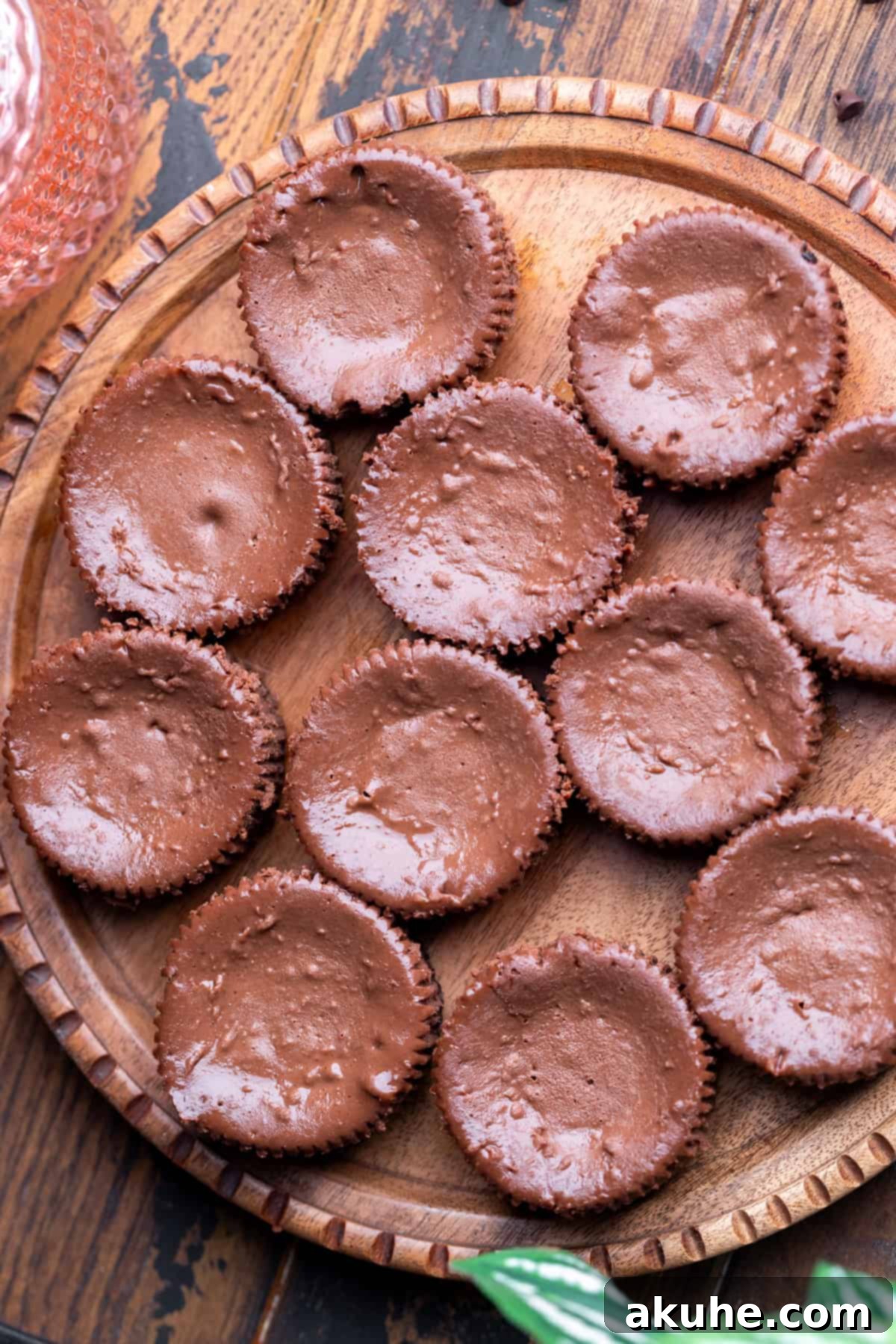 Bite-Sized Chocolate Cheesecakes 7 Freshly baked mini chocolate cheesecakes on a wooden board, cooled and ready for their delicious toppings.