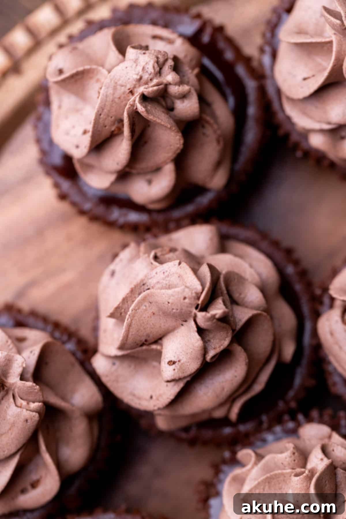 Bite-Sized Chocolate Cheesecakes 9 Elegant swirls of chocolate whipped cream piped onto the ganache-topped mini cheesecakes, ready for serving.