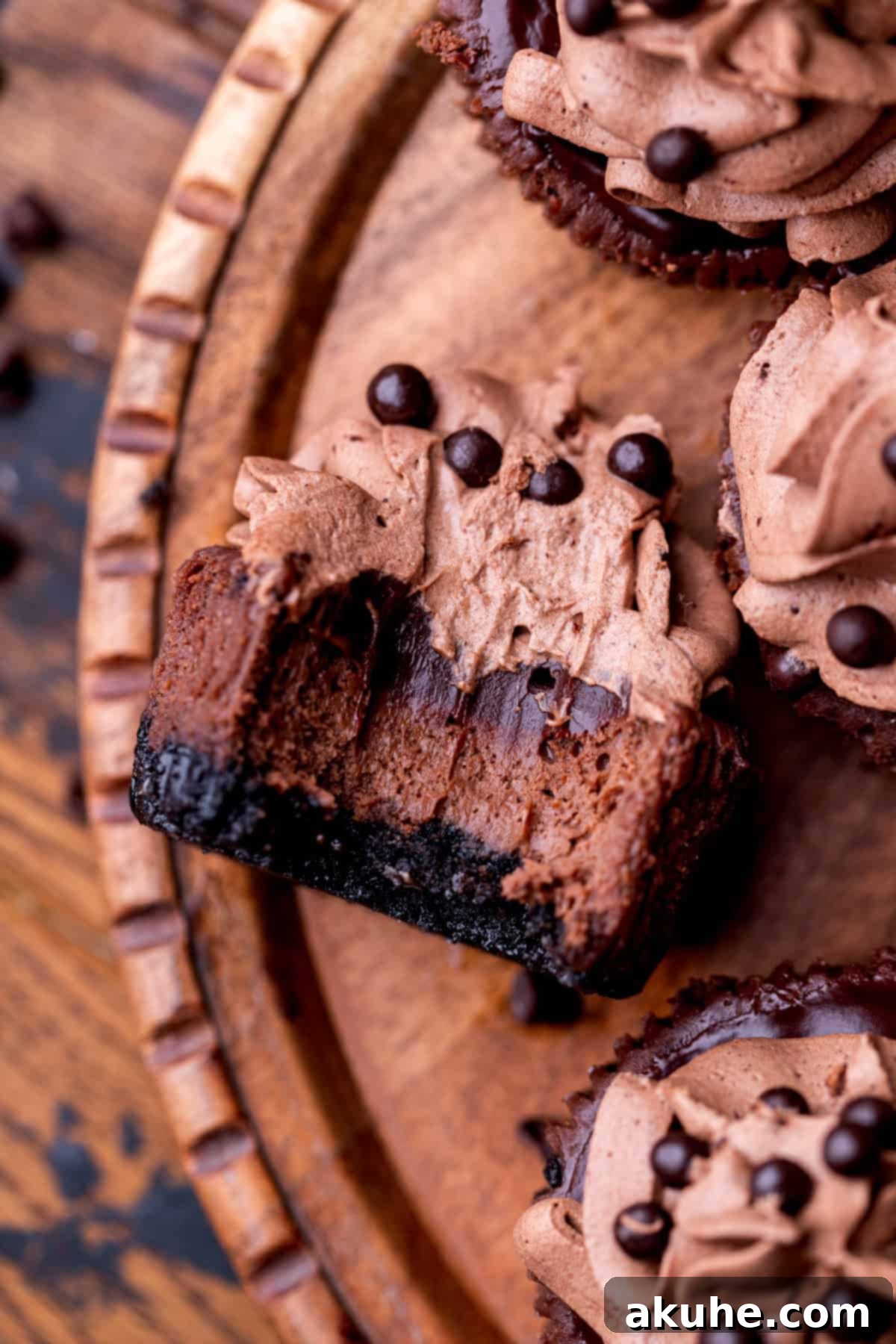 Bite-Sized Chocolate Cheesecakes 10 Top-down view of a mini chocolate cheesecake, highlighting its pristine presentation with a small bite taken out.