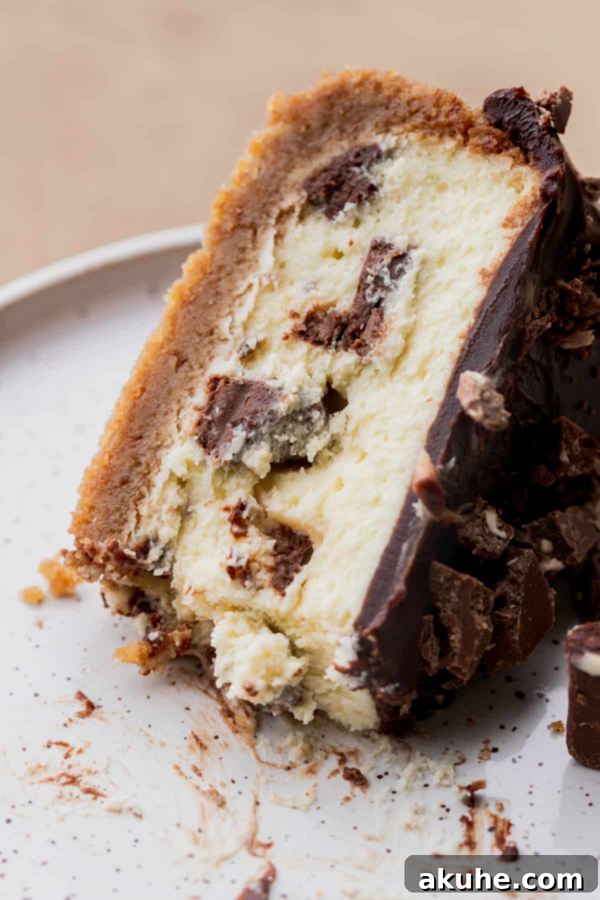 Decadent Toblerone Cheesecake 13 Close-up shot of a slice of Toblerone cheesecake, highlighting the chopped chocolate pieces and creamy texture.