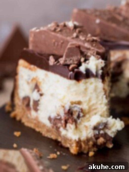 Decadent Toblerone Cheesecake 14 One slice of toblerone cheesecake with a bite missing, showcasing its rich layers and creamy texture.