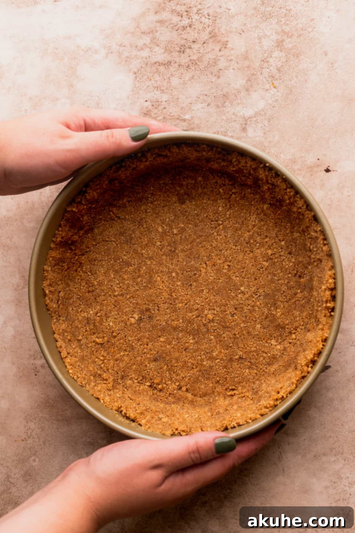 Decadent Toblerone Cheesecake 5 Graham cracker crust meticulously pressed into a springform pan, ready for baking.