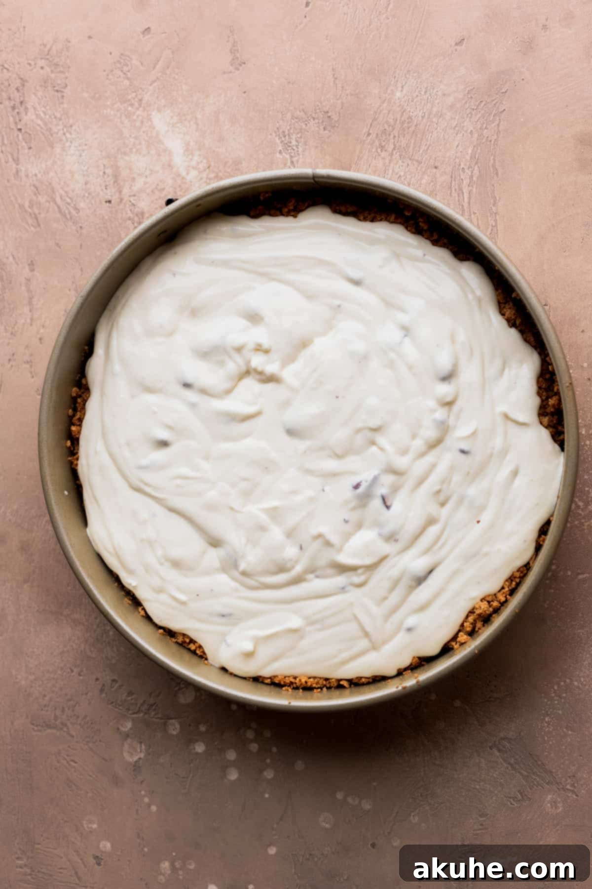 Decadent Toblerone Cheesecake 8 Cheesecake batter smoothly poured into a springform pan, ready for its water bath.