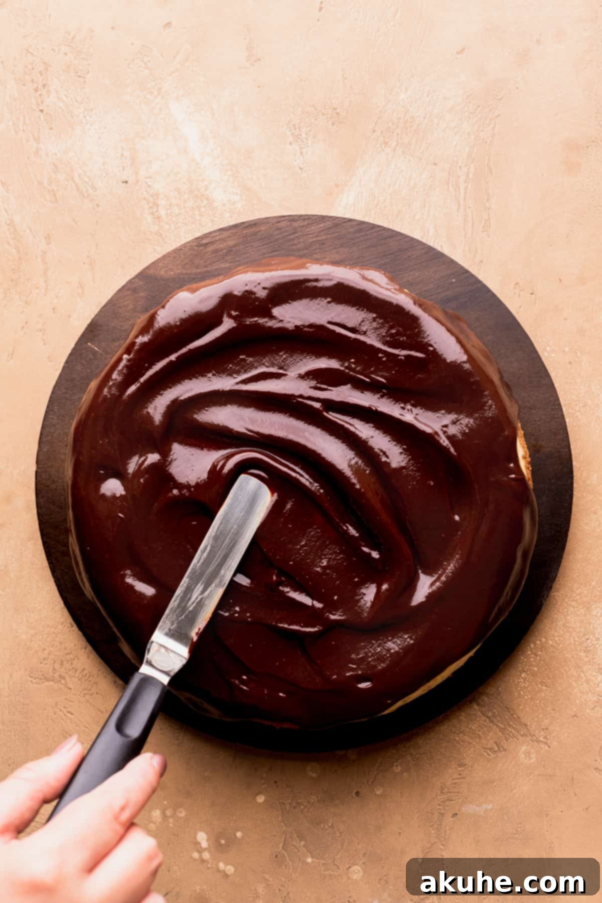 Decadent Toblerone Cheesecake 10 Lustrous chocolate ganache being poured over the top of a chilled cheesecake.