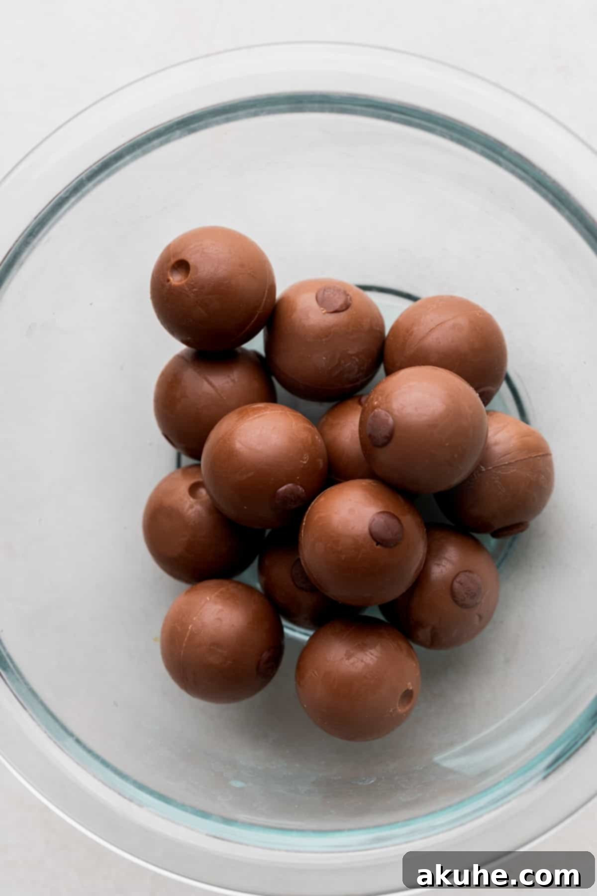A bowl of rich Lindt truffles, showcasing their smooth chocolate shell, ready to be melted and incorporated into the decadent cake.