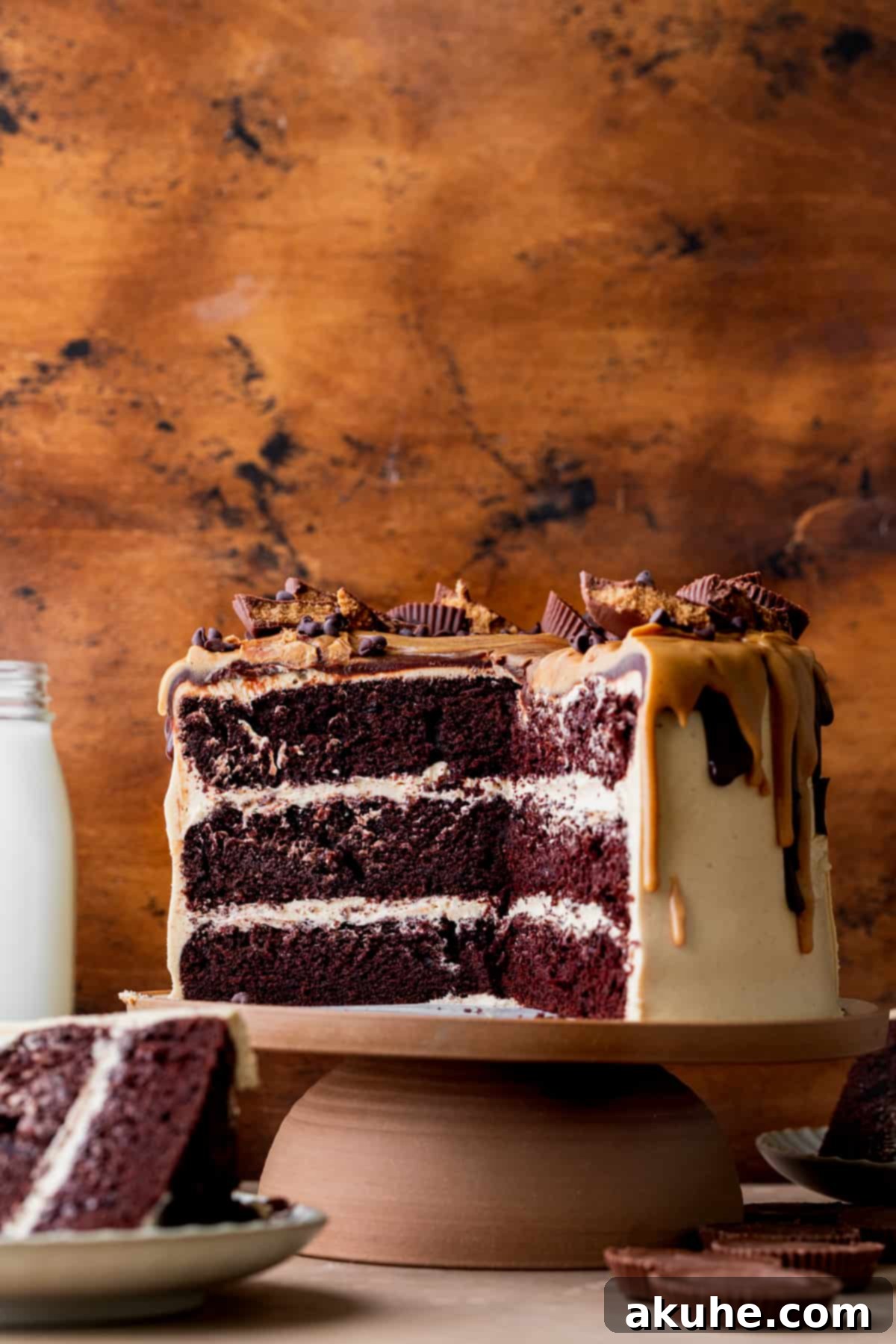 Decadent Peanut Butter Chocolate Cake 2 Cut open chocolate peanut butter cake, showcasing its layers of moist chocolate cake and creamy peanut butter frosting.