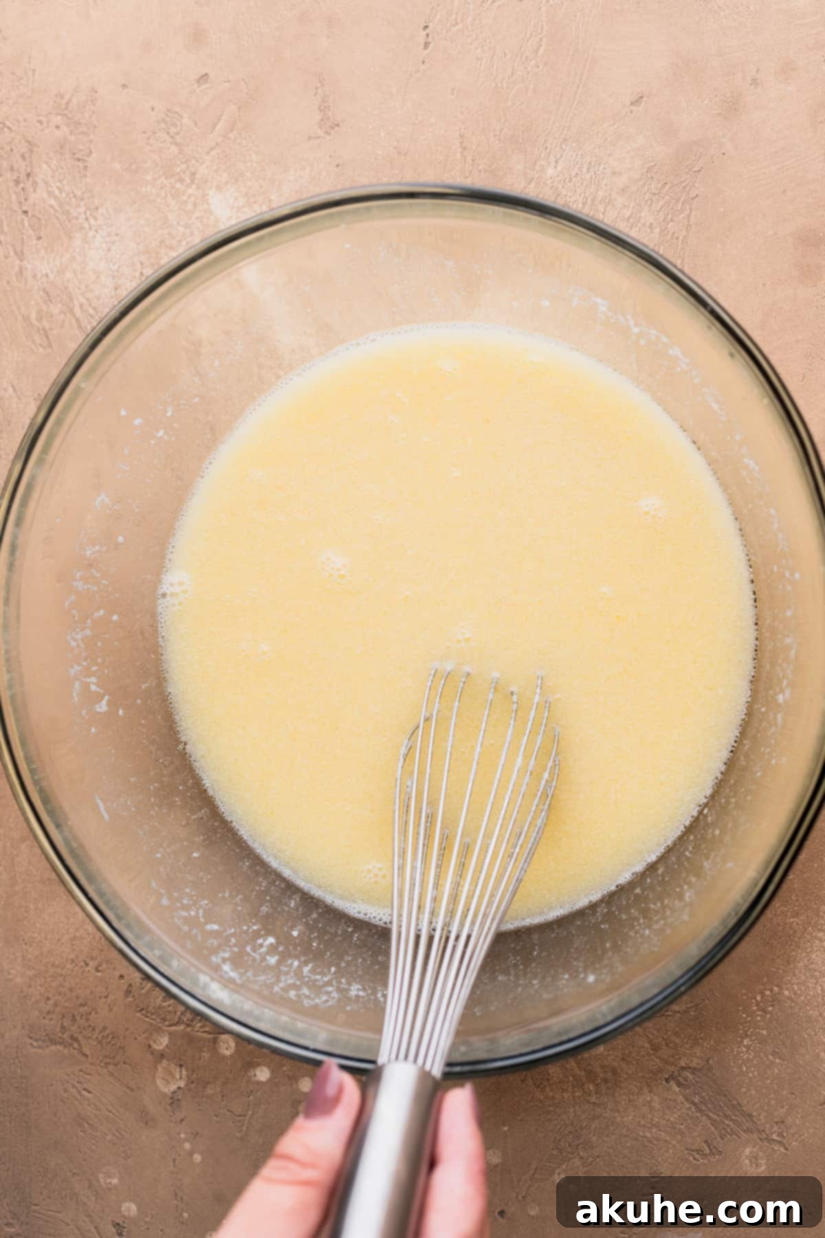 Decadent Peanut Butter Chocolate Cake 4 Wet ingredients (oil, vanilla, eggs, buttermilk) being mixed in a bowl.