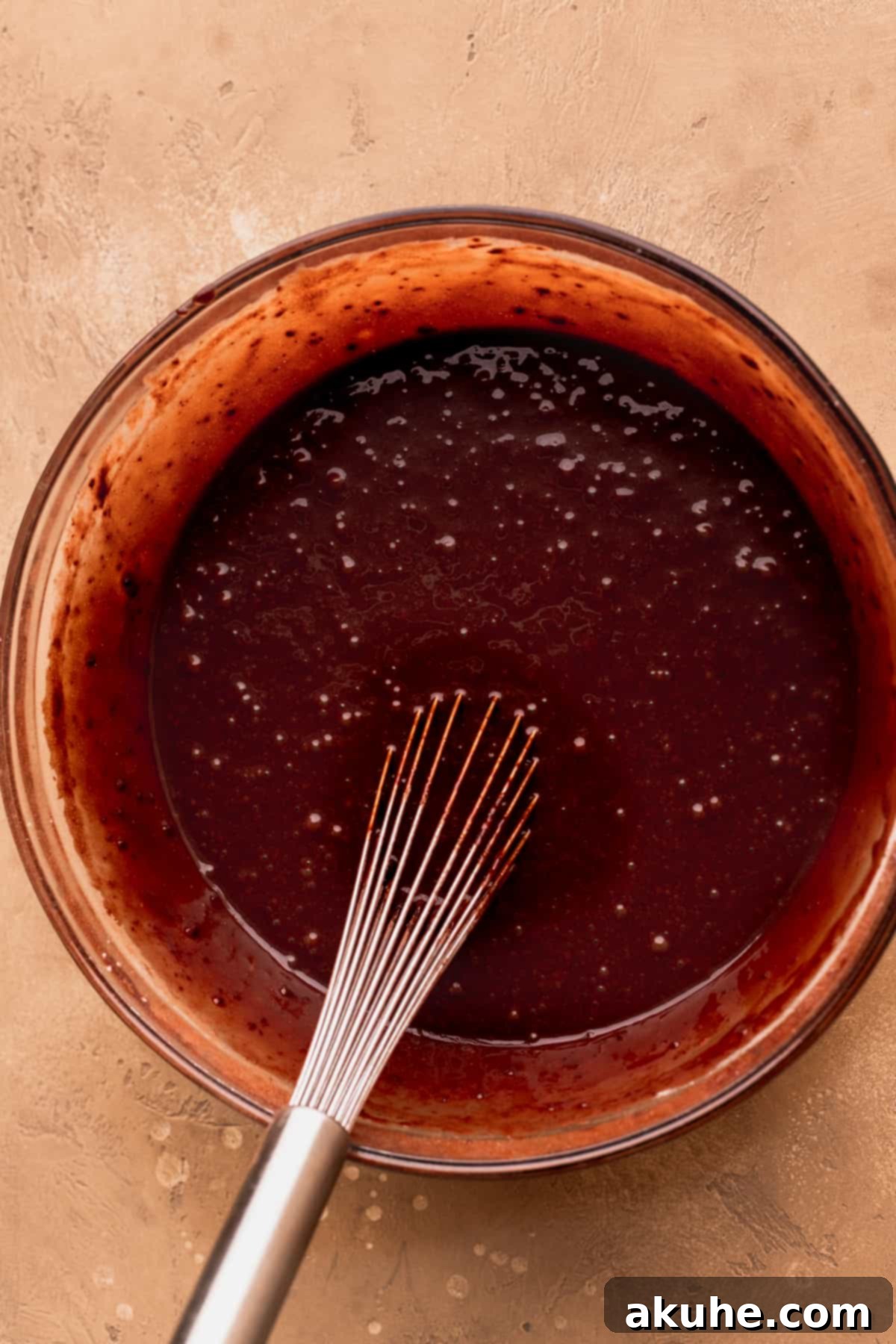 Decadent Peanut Butter Chocolate Cake 5 Smooth chocolate cake batter ready for baking in a clear glass bowl.