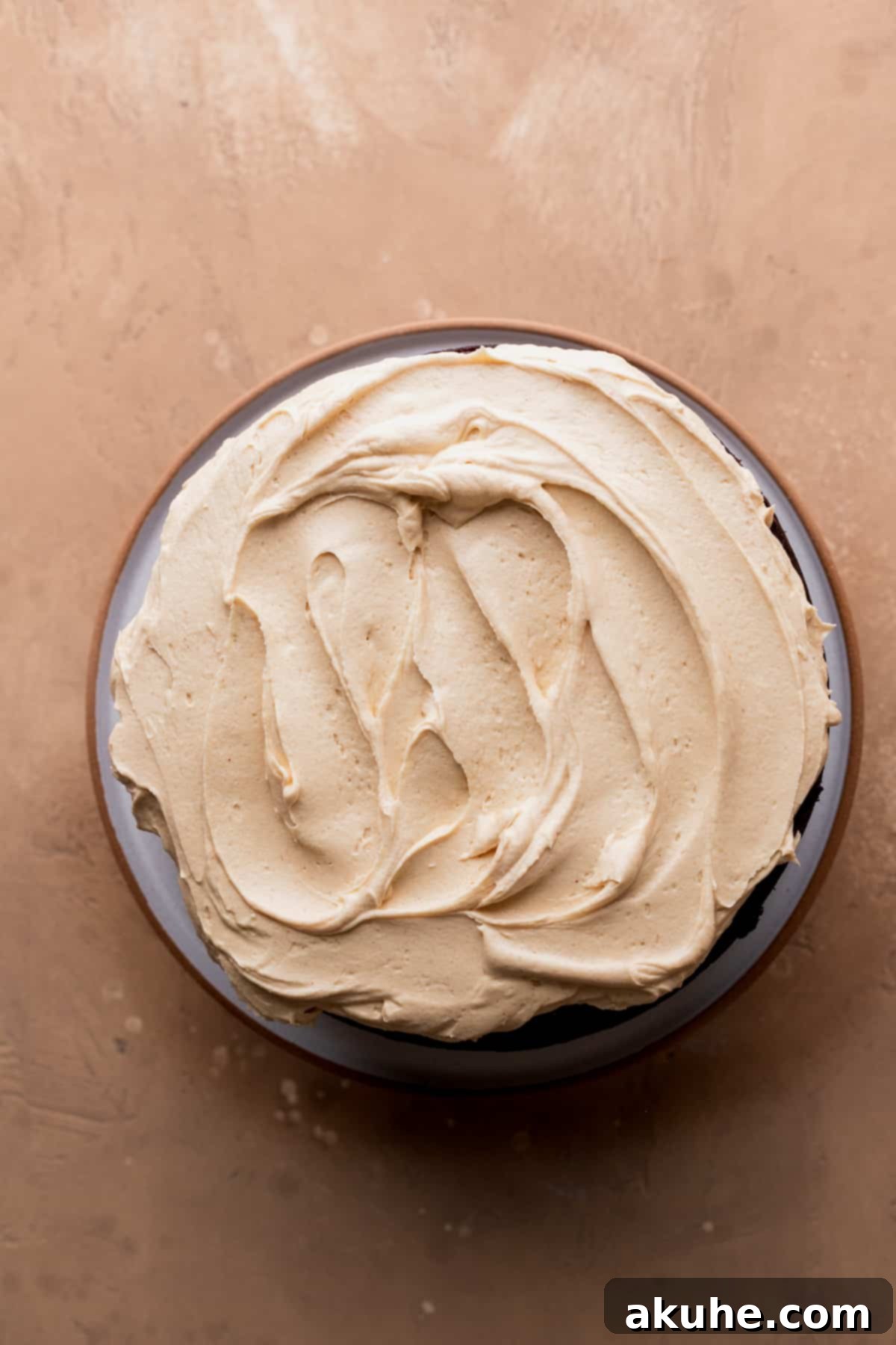 Decadent Peanut Butter Chocolate Cake 8 Close-up of the first cake layer frosted with peanut butter frosting.