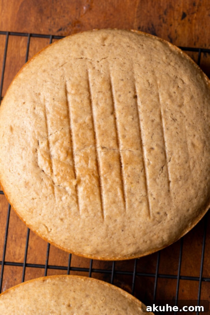 Freshly baked cake layers resting on a wire rack to cool.