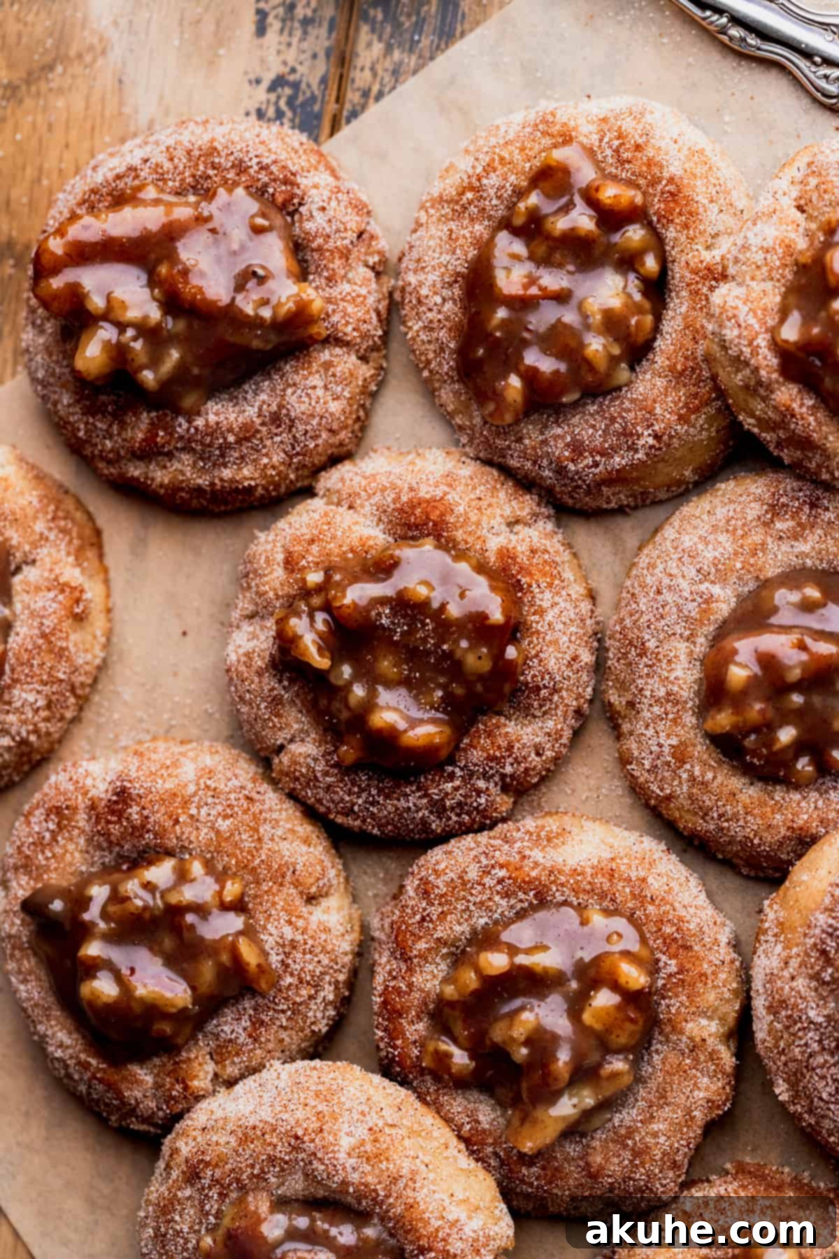 Southern Pecan Pie Cookies 2 Pecan pie cookies coated in cinnamon sugar, showcasing their perfect texture and inviting golden hue.