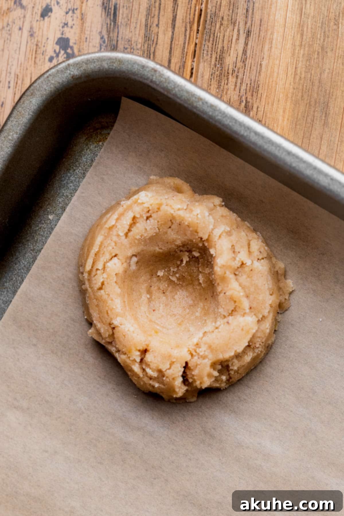 Southern Pecan Pie Cookies 7 Cookie dough ball with a neat indentation in the middle, prepared for the filling.