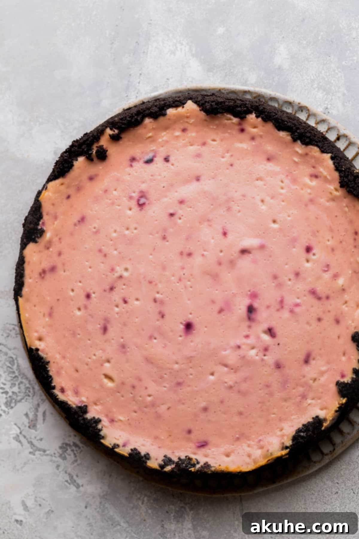 Decadent Cherry Cheesecake 8 Baked cheesecake on a board.