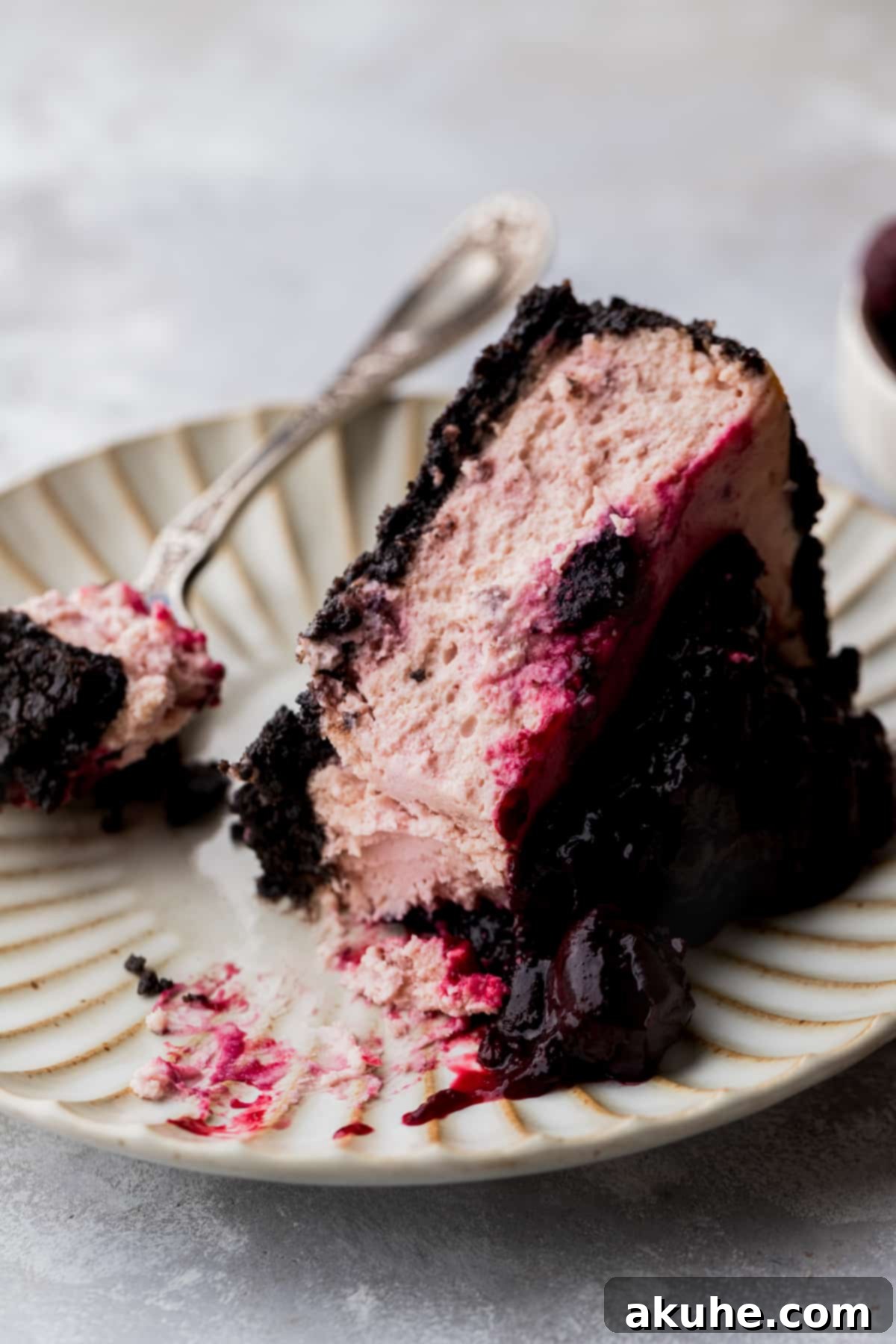 Decadent Cherry Cheesecake 10 One slice of cherry cheesecake on a plate.