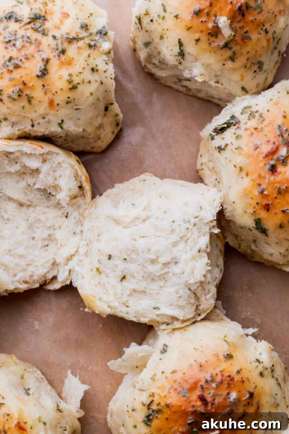Fresh Baked Garlic Rolls 3 A baked garlic roll split in half, showing its fluffy interior.