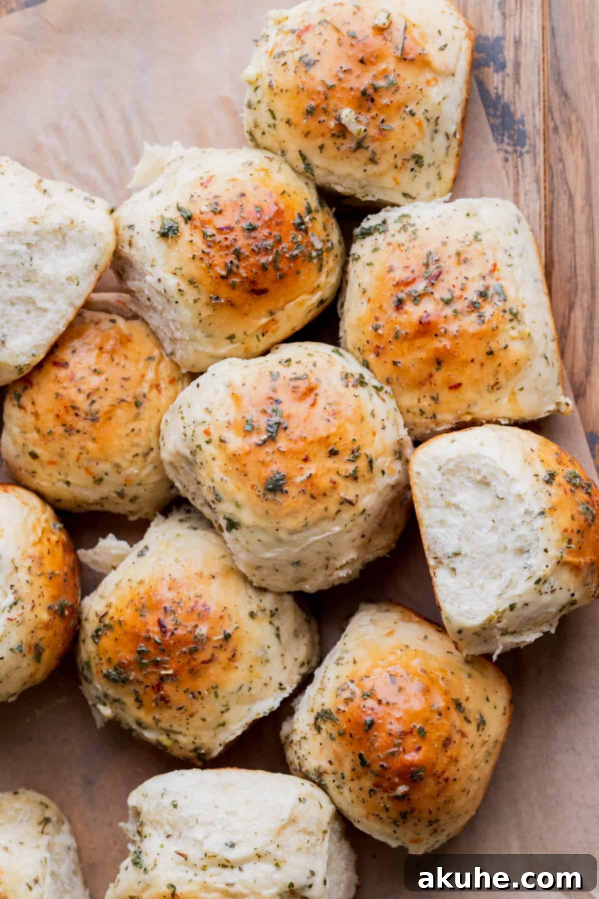 Fresh Baked Garlic Rolls 8 Baked garlic rolls artfully arranged on parchment paper.