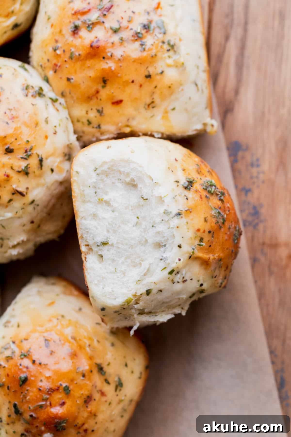 Fresh Baked Garlic Rolls 9 A single garlic roll resting on its side, showcasing its golden crust.