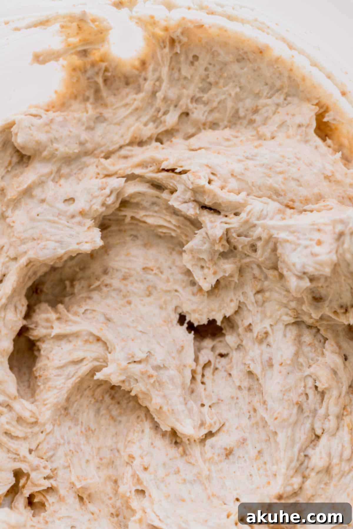 A close-up of the rich, creamy graham cracker cream cheese frosting, showing its perfect texture and flecks of graham cracker.