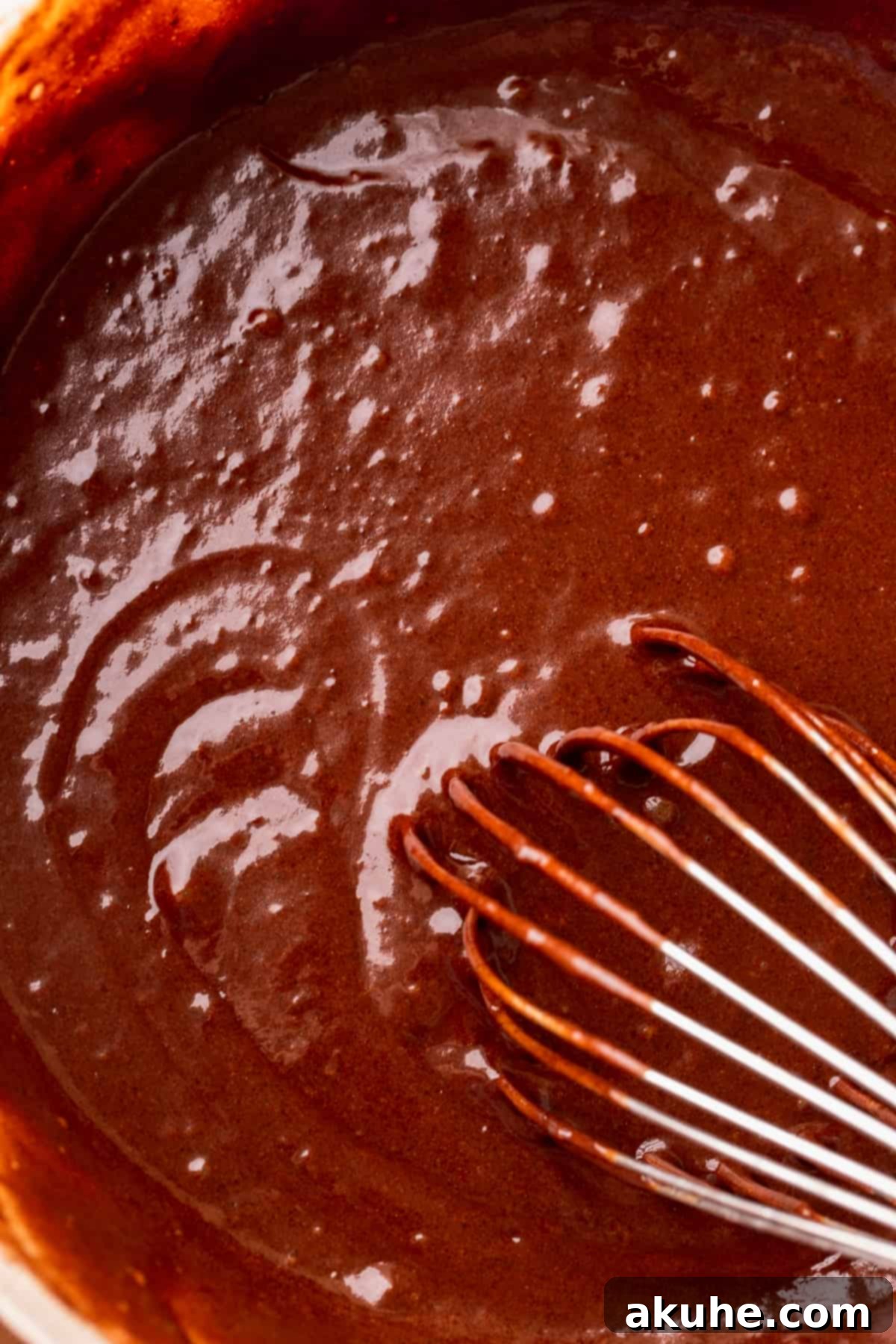 Velvet Chocolate Ganache Torte 5 Smooth and rich chocolate cake batter sitting in a glass mixing bowl, ready for baking.