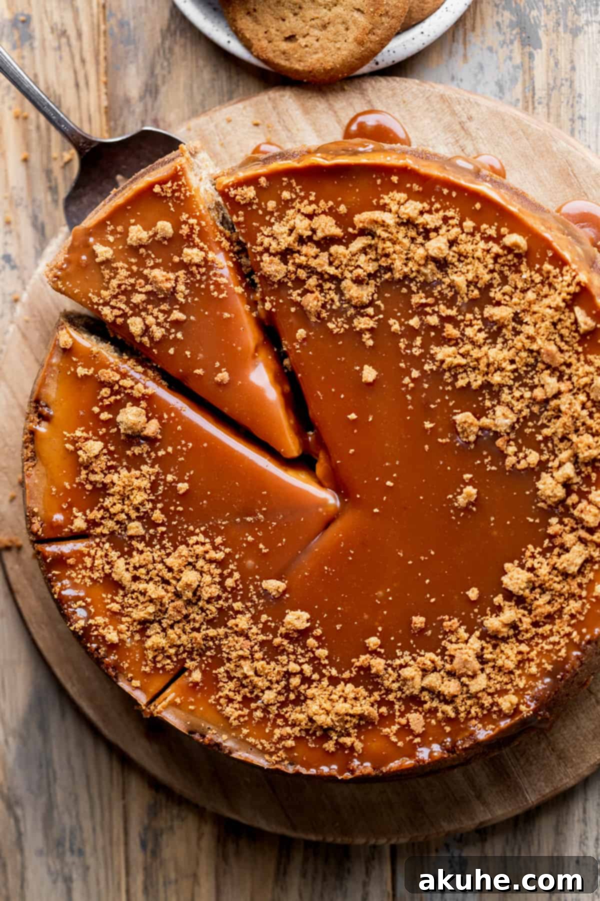 Gingerbread Dream Cheesecake 3 Taking a slice out of the gingerbread cheesecake.