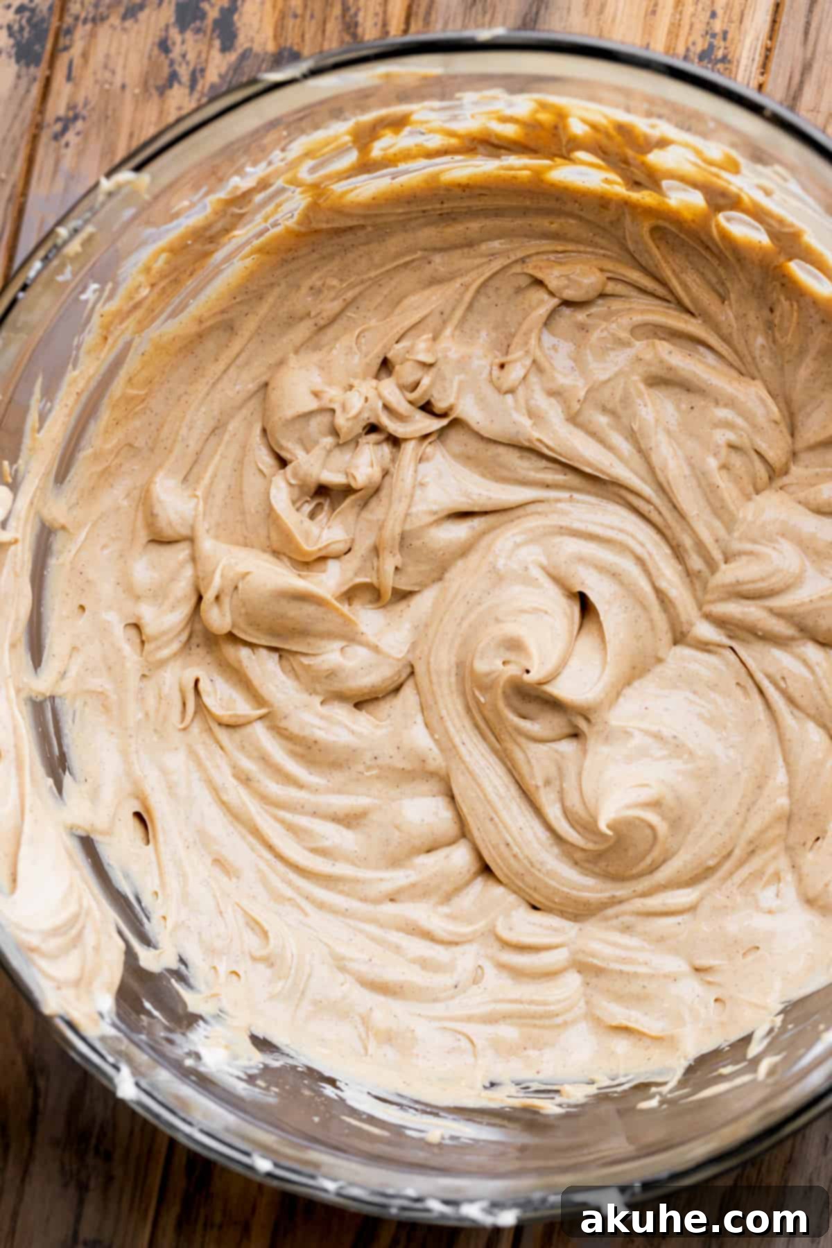 Gingerbread Dream Cheesecake 7 Whipped wet ingredients in a glass bowl.