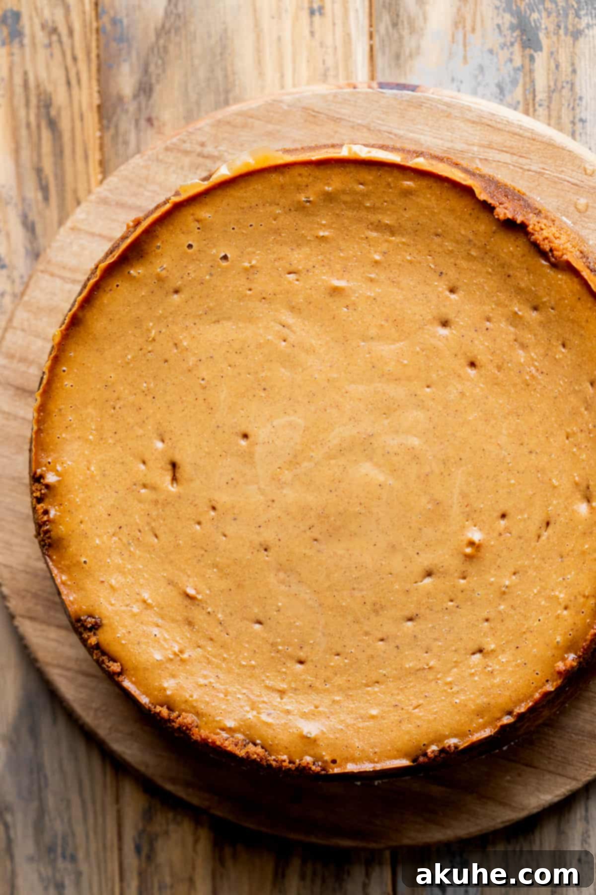 Gingerbread Dream Cheesecake 10 Baked cheesecake on a board.