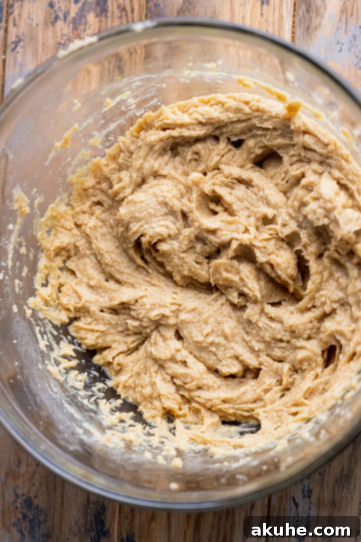 Wet ingredients in a mixing bowl after eggs and vanilla have been added and mixed.