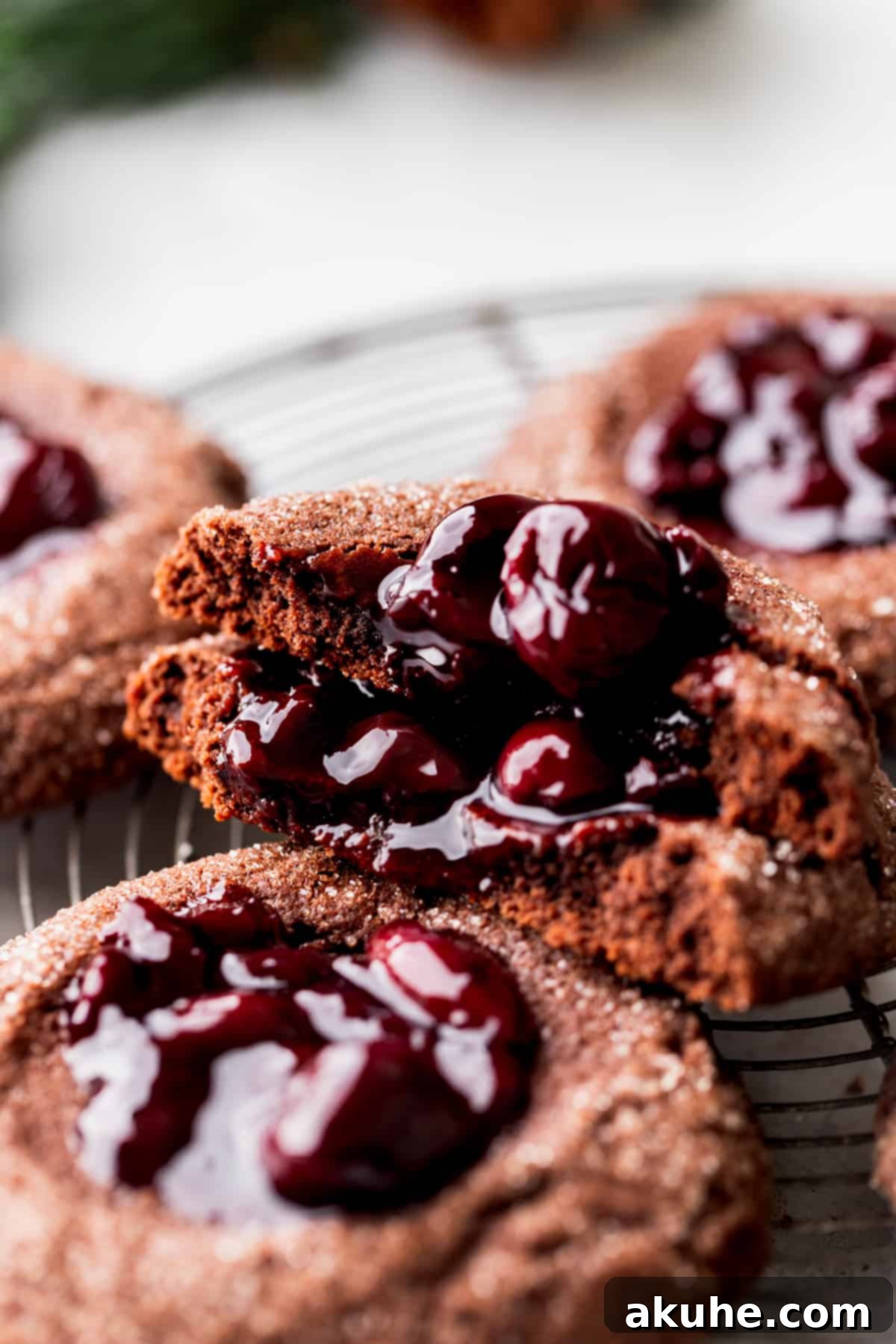 Decadent Chocolate Cherry Cookies 10 A chocolate cherry cookie split in half, perfectly displaying its fudgy texture and juicy cherry filling.