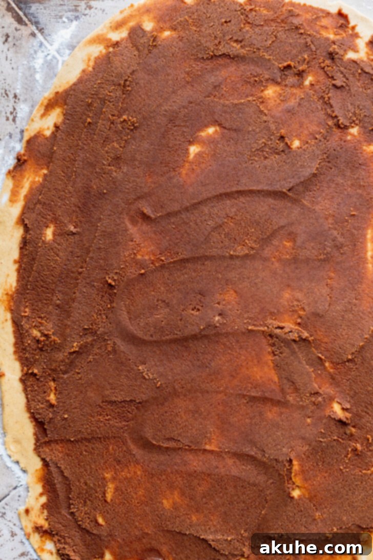 Spiced Gingerbread Swirl Buns 5 Spiced gingerbread filling generously spread over the rolled-out dough, ready for shaping.