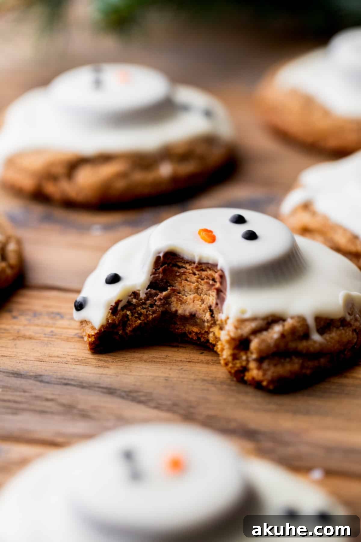 A gingerbread snowman cookie with a bite taken out, showing the rich texture inside.