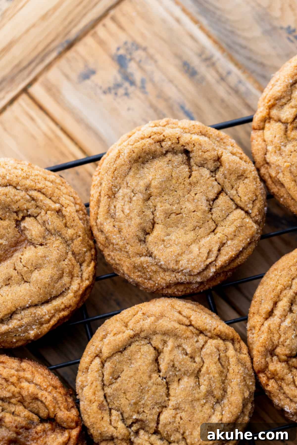 Freshly baked gingerbread cookies cooling on a wire rack after being removed from the oven.