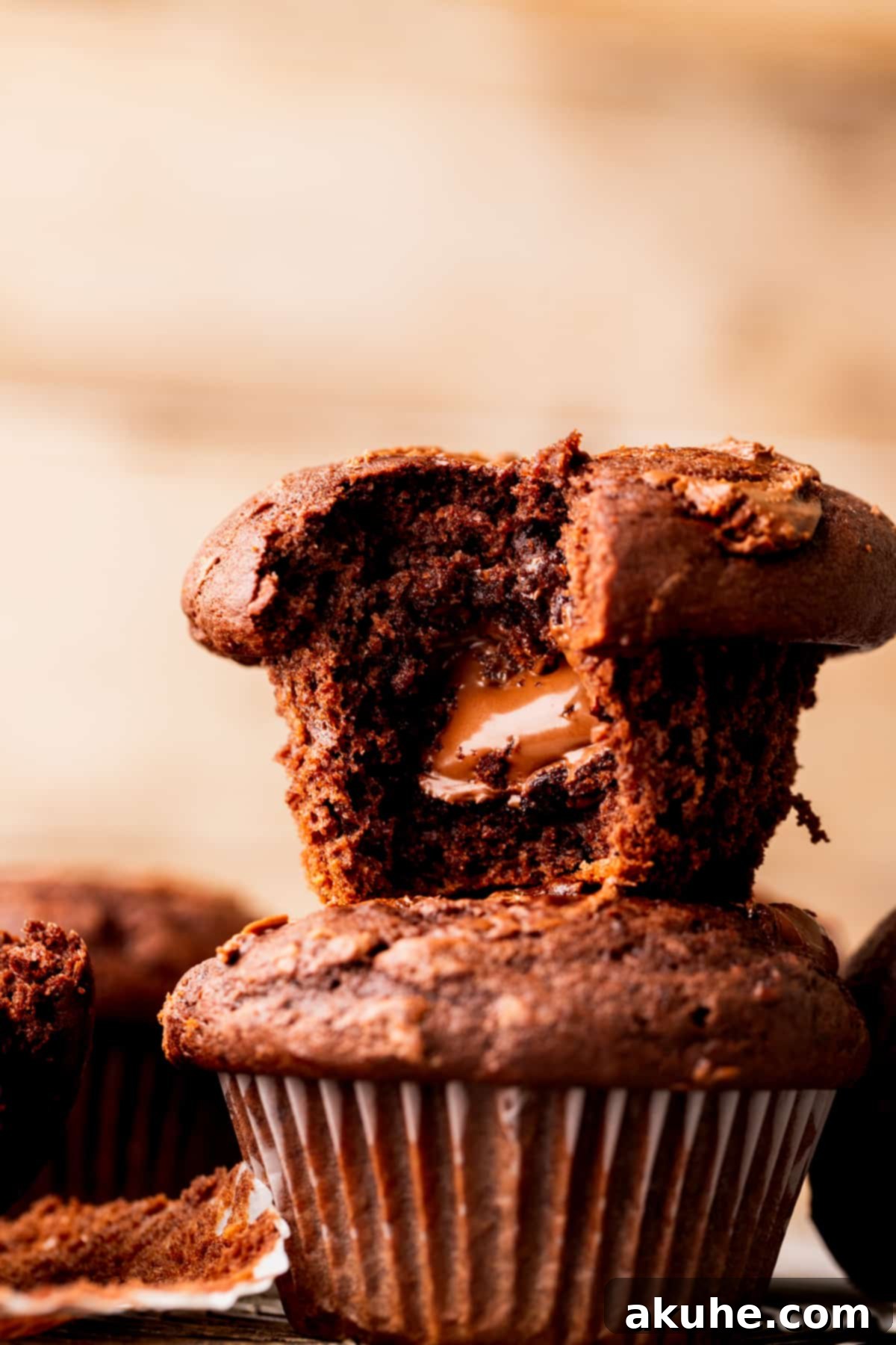 A close-up of a Nutella muffin, split open to reveal its irresistible gooey center, with a bite taken out.