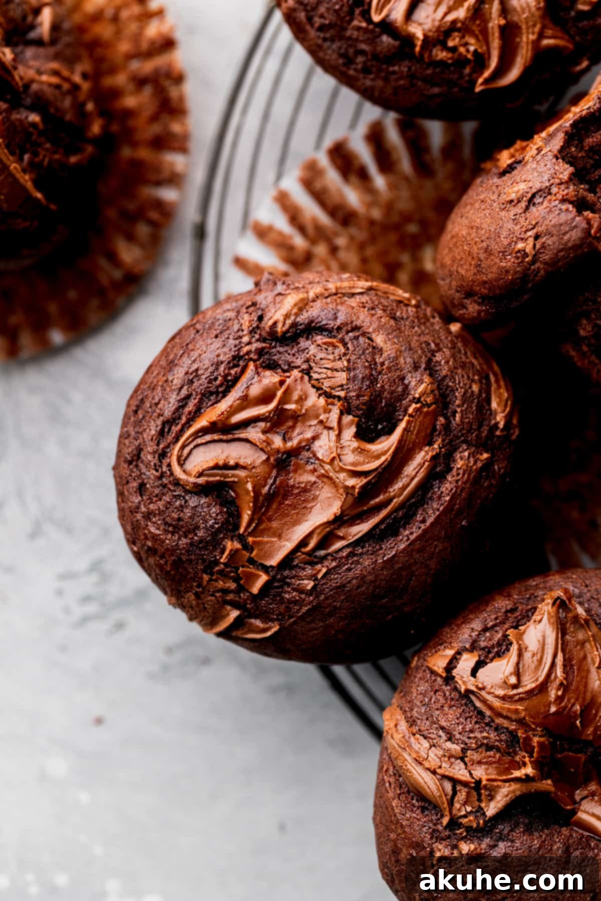 Close-up aerial view of a beautifully baked Nutella muffin, showing its perfectly domed top and rich texture.