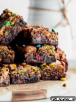 Fudgy Monster Cookie Brownies 9 Stack of monster cookie brownie bars.