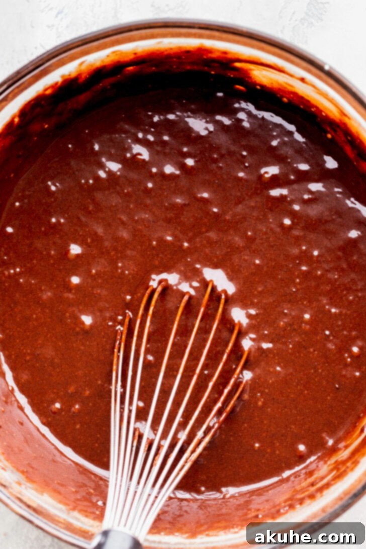 Fudgy Brownie Cake 4 Thick, smooth chocolate cake batter in a large mixing bowl, ready for baking
