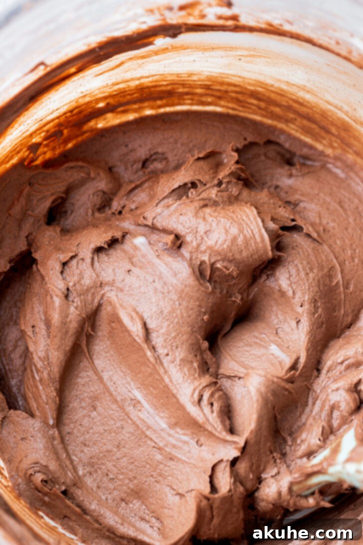 Fudgy Brownie Cake 9 Velvety smooth chocolate cream cheese frosting in a mixing bowl, perfectly whipped and ready for decorating