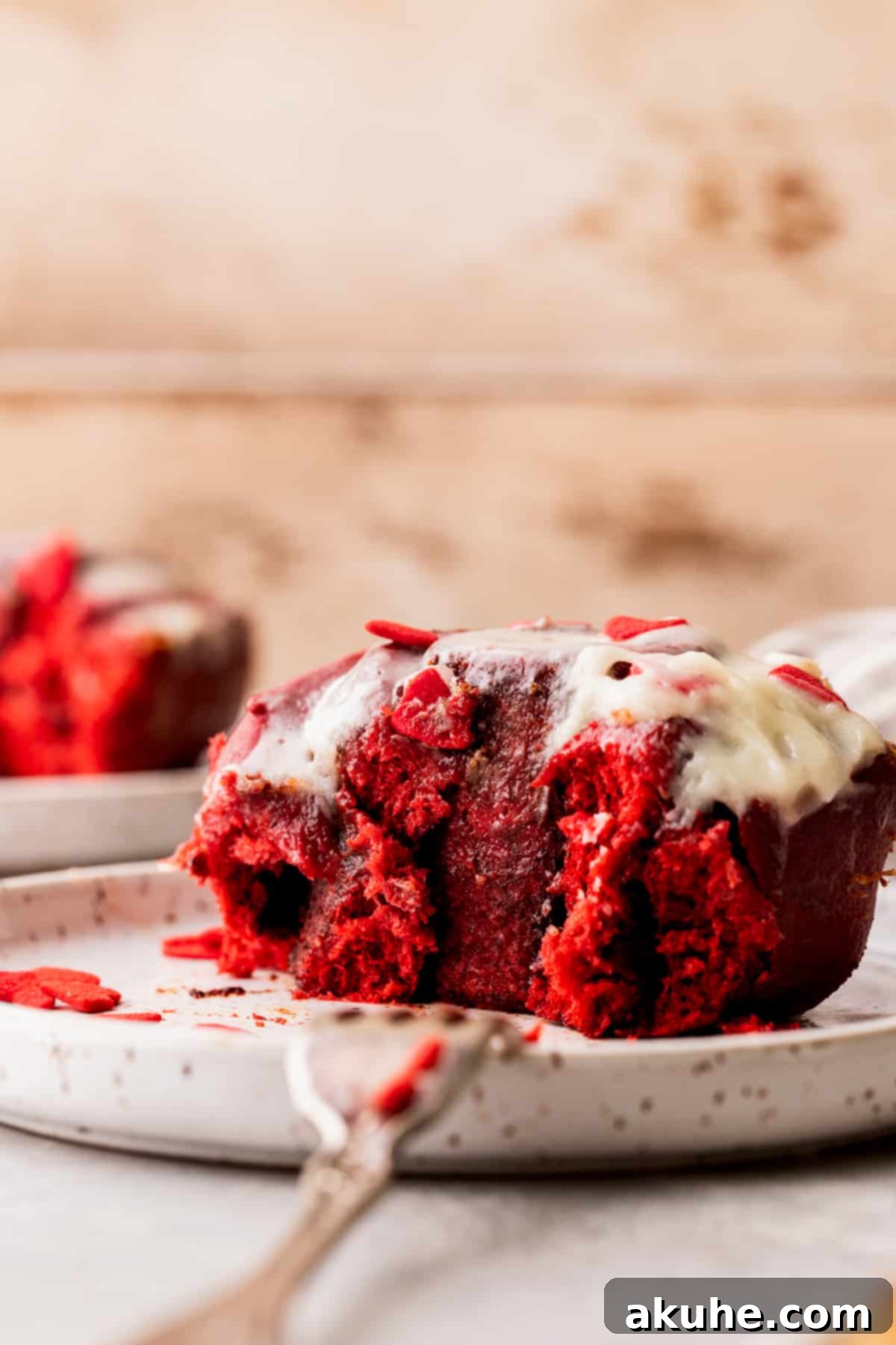 Decadent Red Velvet Cinnamon Rolls 14 Cinnamon roll on a plate.