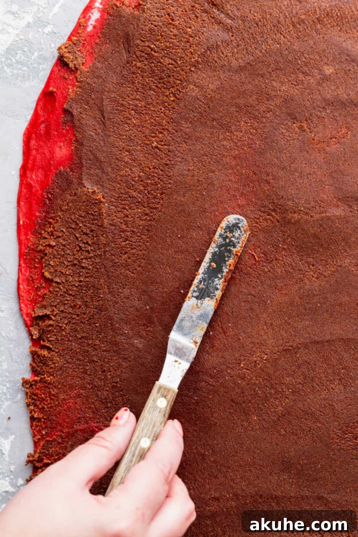 Decadent Red Velvet Cinnamon Rolls 8 Spreading filling on top of dough.